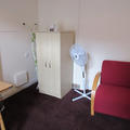 Rewley House - Accommodation - (4 of 9) - Armchair and wardrobe